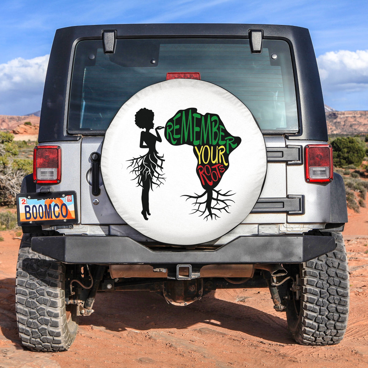 White spare tire cover with 'Remember Your Roots' silhouettes, African-inspired Juneteenth design