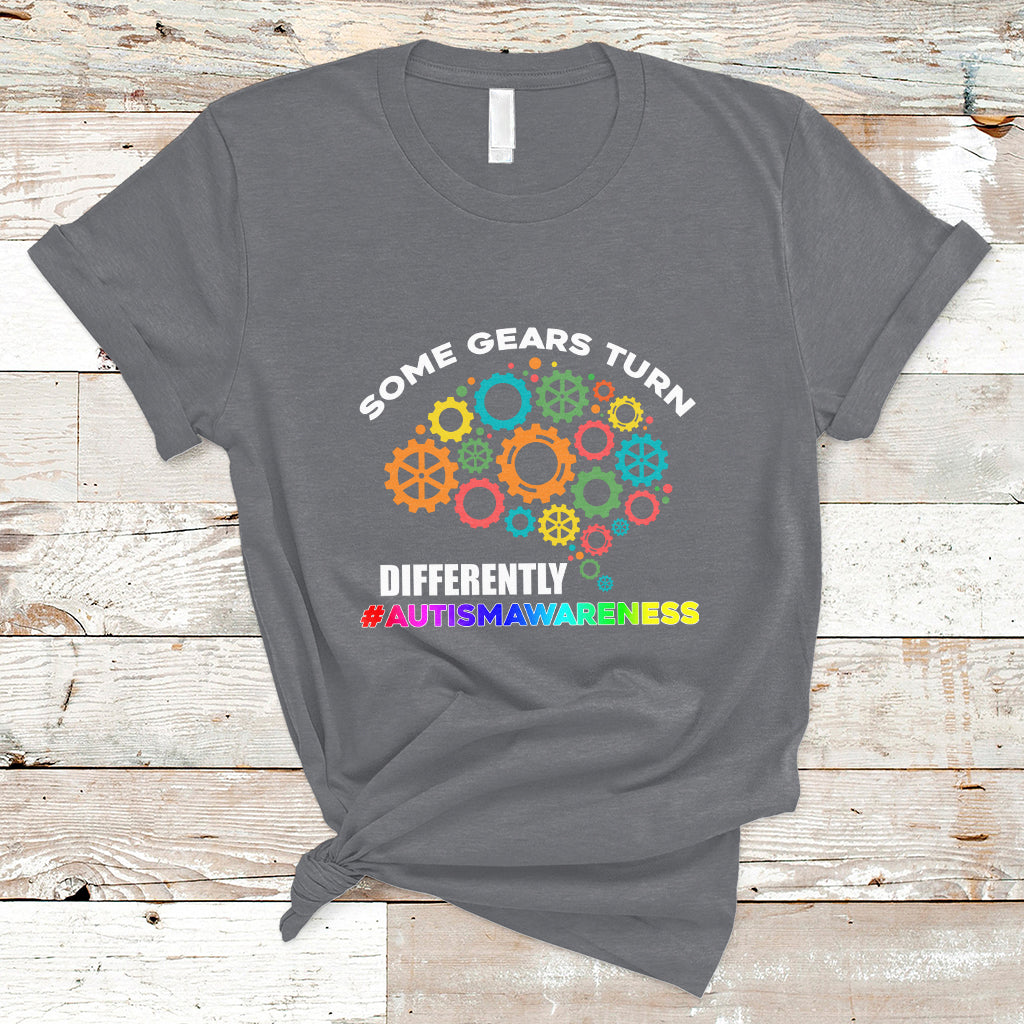 Charcoal autism awareness graphic T-shirt with colorful gears and slogan text