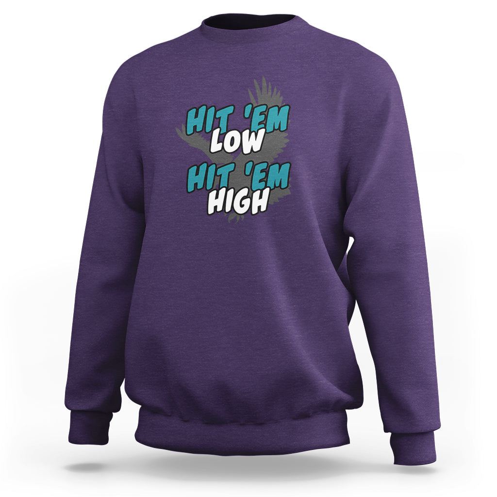 Purple groovy sweatshirt with "Hit 'Em Low" "Hit 'Em High" chest graphic