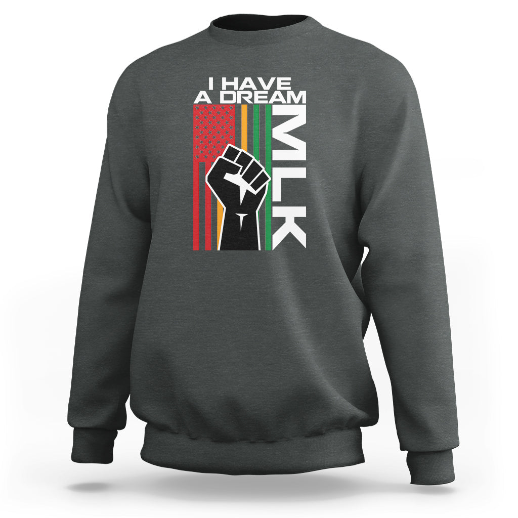 Dark heather crewneck sweatshirt with “I HAVE A DREAM” text and raised-fist graphic