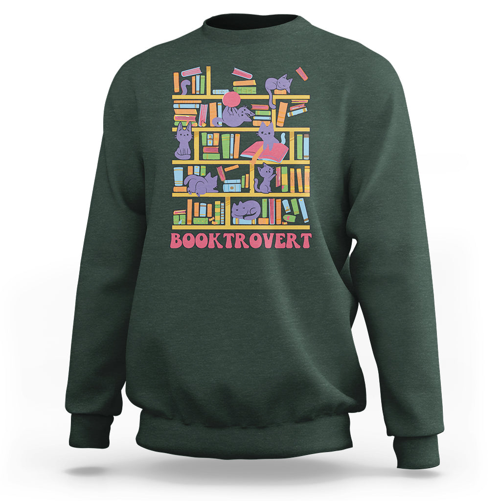 Forest green crewneck sweatshirt with colorful cat-and-bookshelf graphic and text