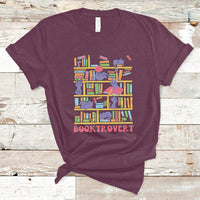 Maroon crew-neck T-shirt with colorful book-and-cat graphic and “BOOKTROVERT” text