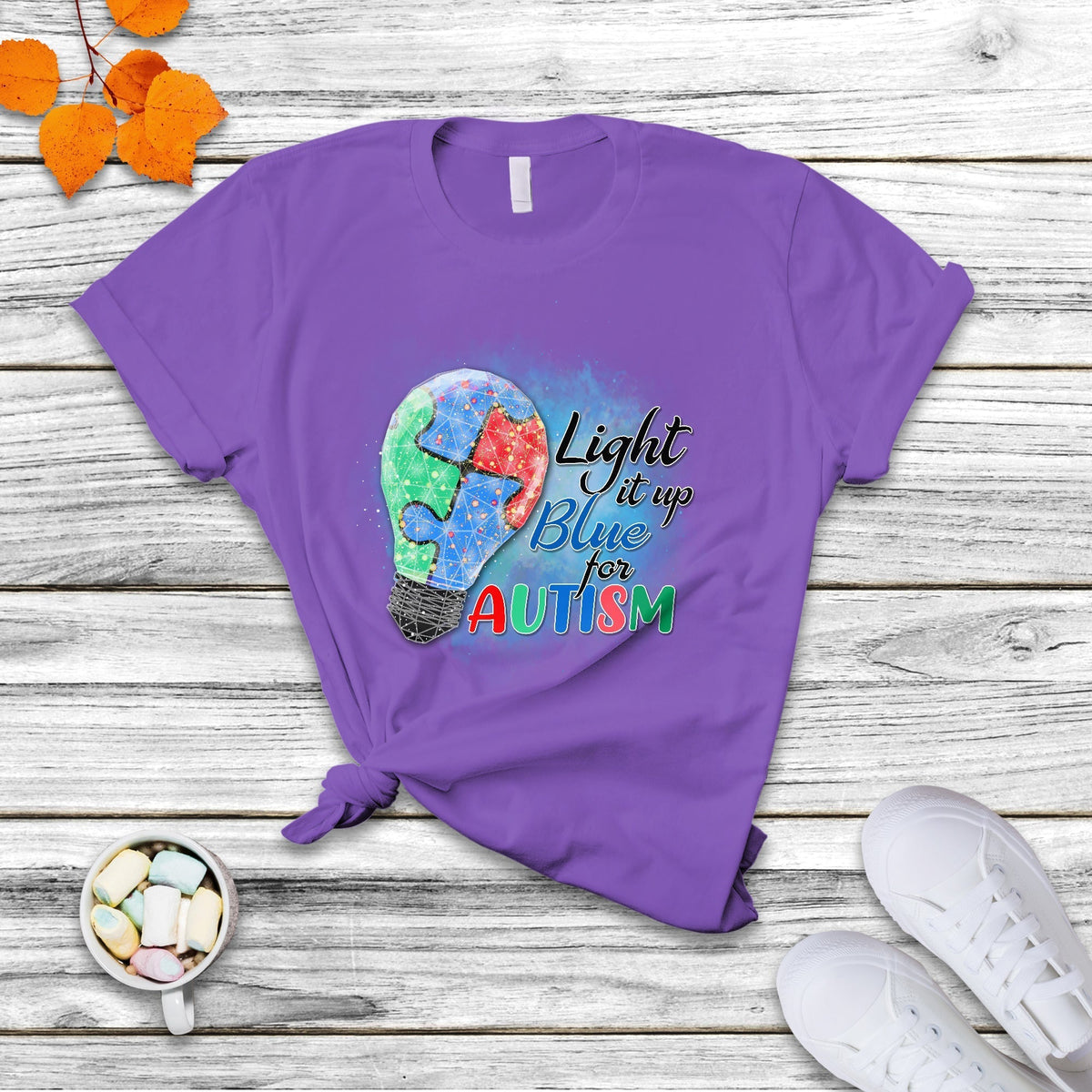Purple autism awareness T-shirt featuring colorful puzzle graphic and “Light it up for Autism”