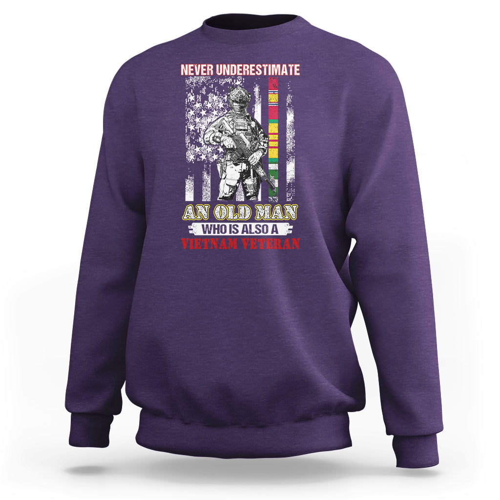 Purple crewneck sweatshirt with Vietnam veteran graphic and striped flag text