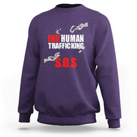 Purple crewneck sweatshirt with 'END HUMAN TRAFFICKING' and red 'S.O.S.' front print