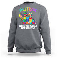 Charcoal gray crewneck sweatshirt with colorful autism graphic and 'Seeing the world differently' print