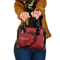 Red heart-pattern shoulder handbag with black top handles and front heart patch