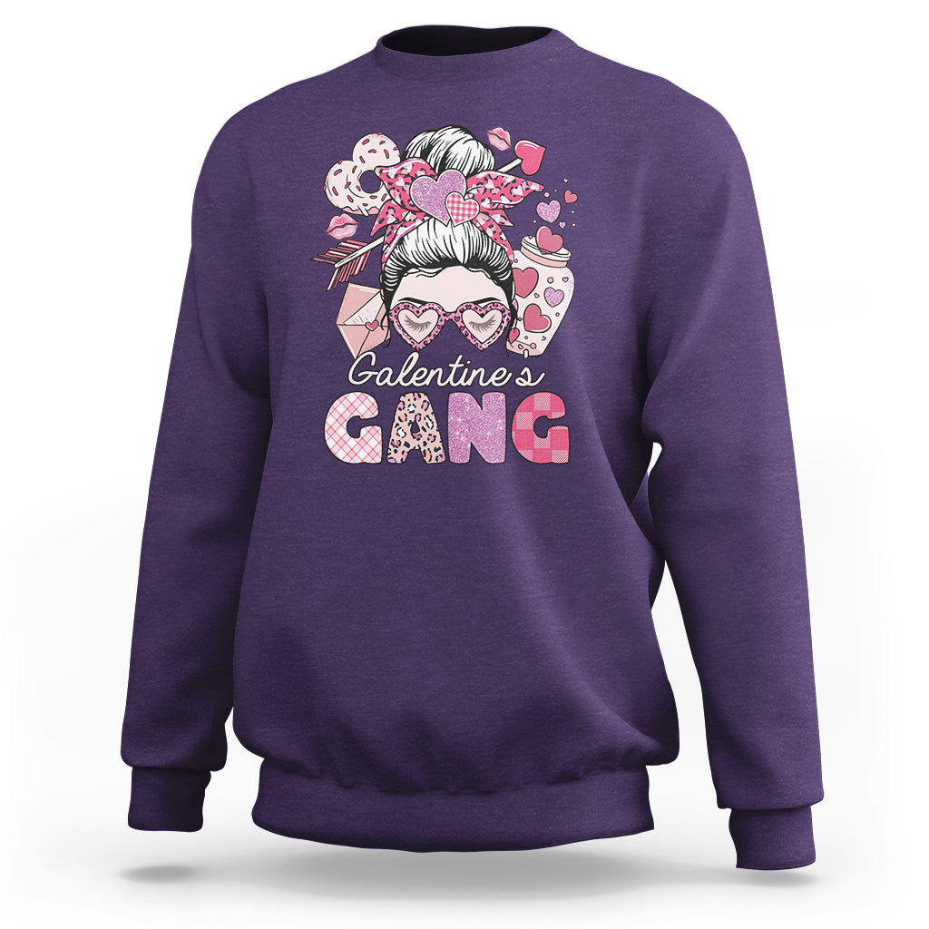 Purple crewneck sweatshirt with "Galentine's Gang" heart graphic and messy bun girl