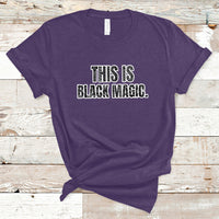 Purple crewneck T-shirt with 'THIS IS BLACK MAGIC' graphic on the front