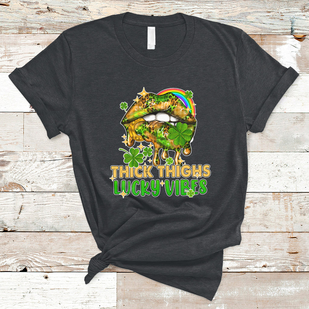 Black short-sleeve graphic T-shirt with rainbow lips and green shamrocks text