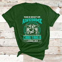Forest green crewneck T-shirt with “Awesome Caretaker Looks Like” graphic on the front