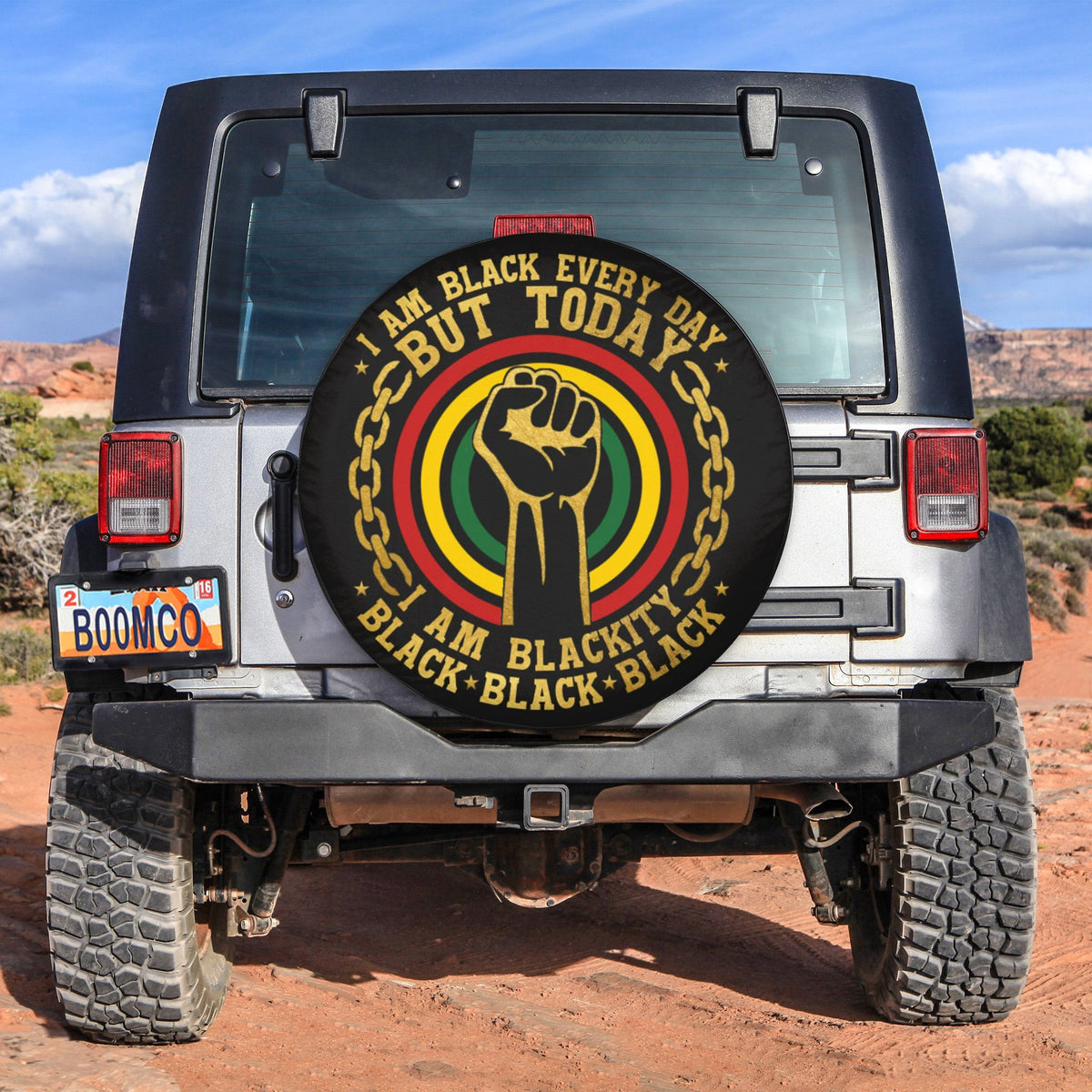 Spare tire cover with circular black fist, chain graphic, and 'I am black' text