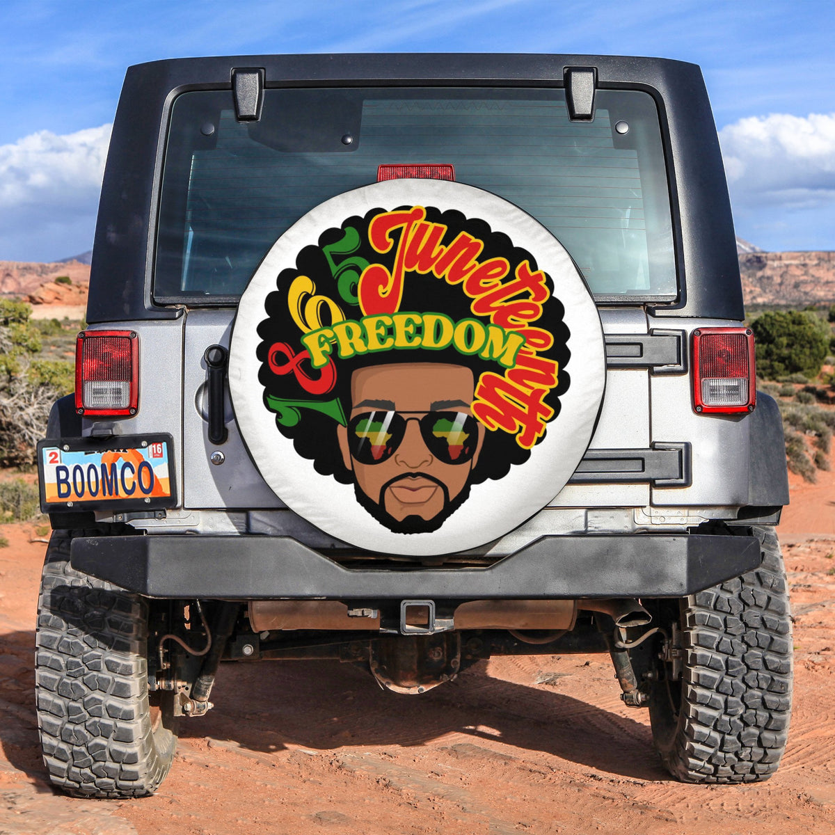 Spare tire cover in black with circular graphic of face, sunglasses, and freedom text