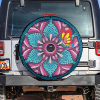 Spare tire cover in turquoise, pink, and magenta with butterfly and central camera window
