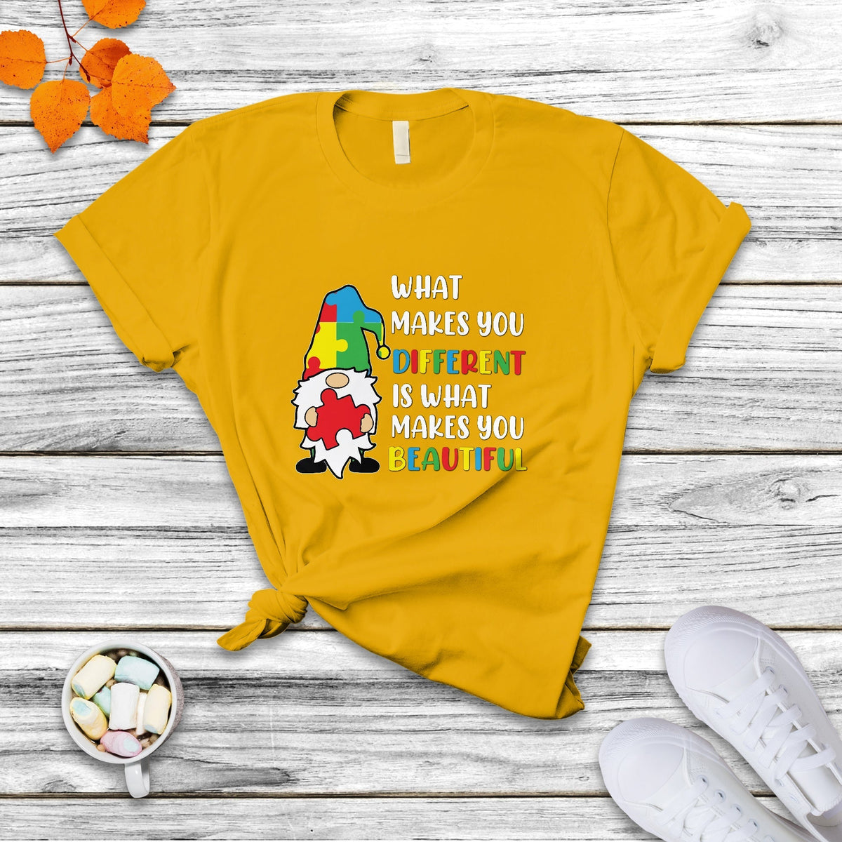 Gold autism support gnome T-shirt with colorful “What makes you different…beautiful” text