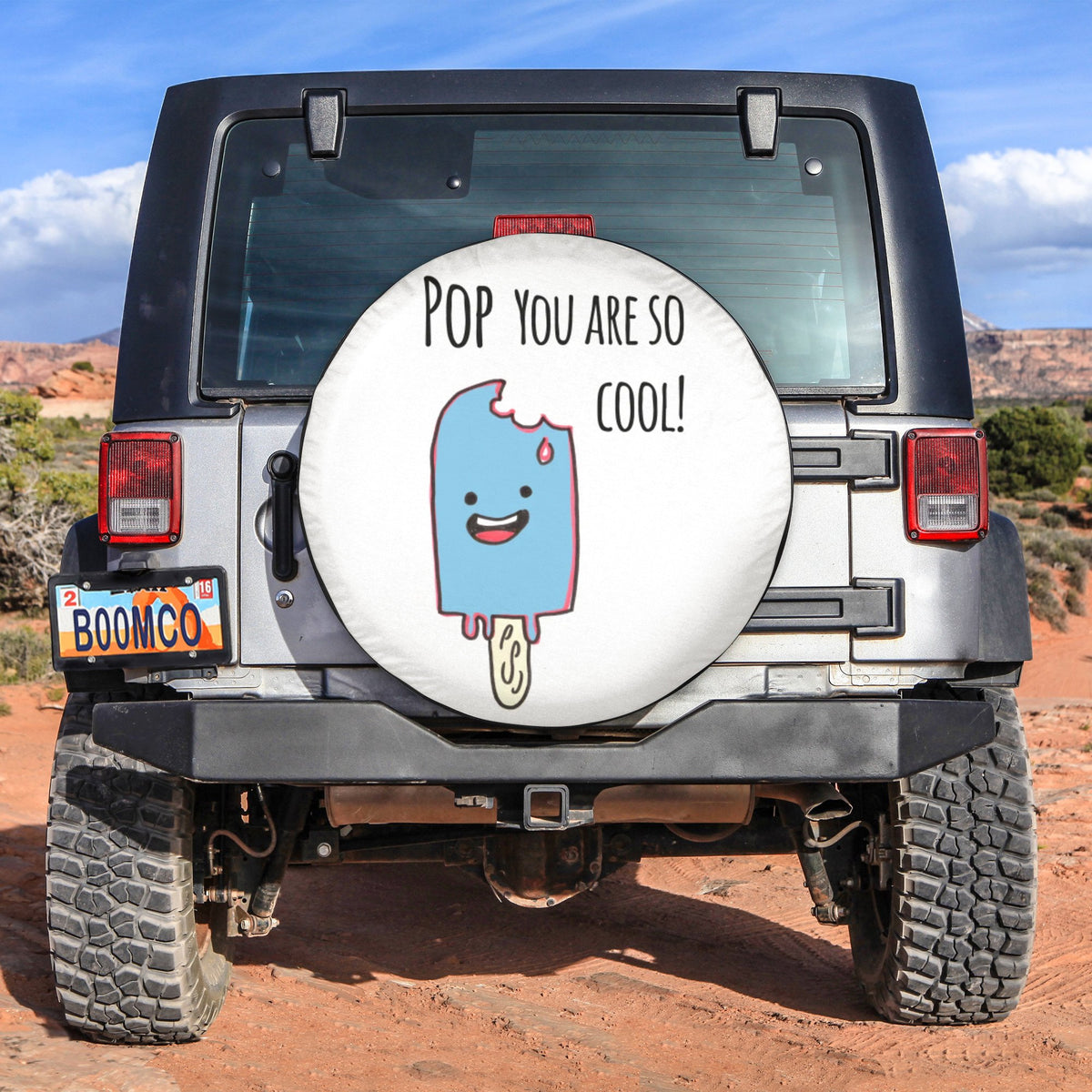 Spare tire cover with white circular graphic and smiling cartoon on rear of vehicle