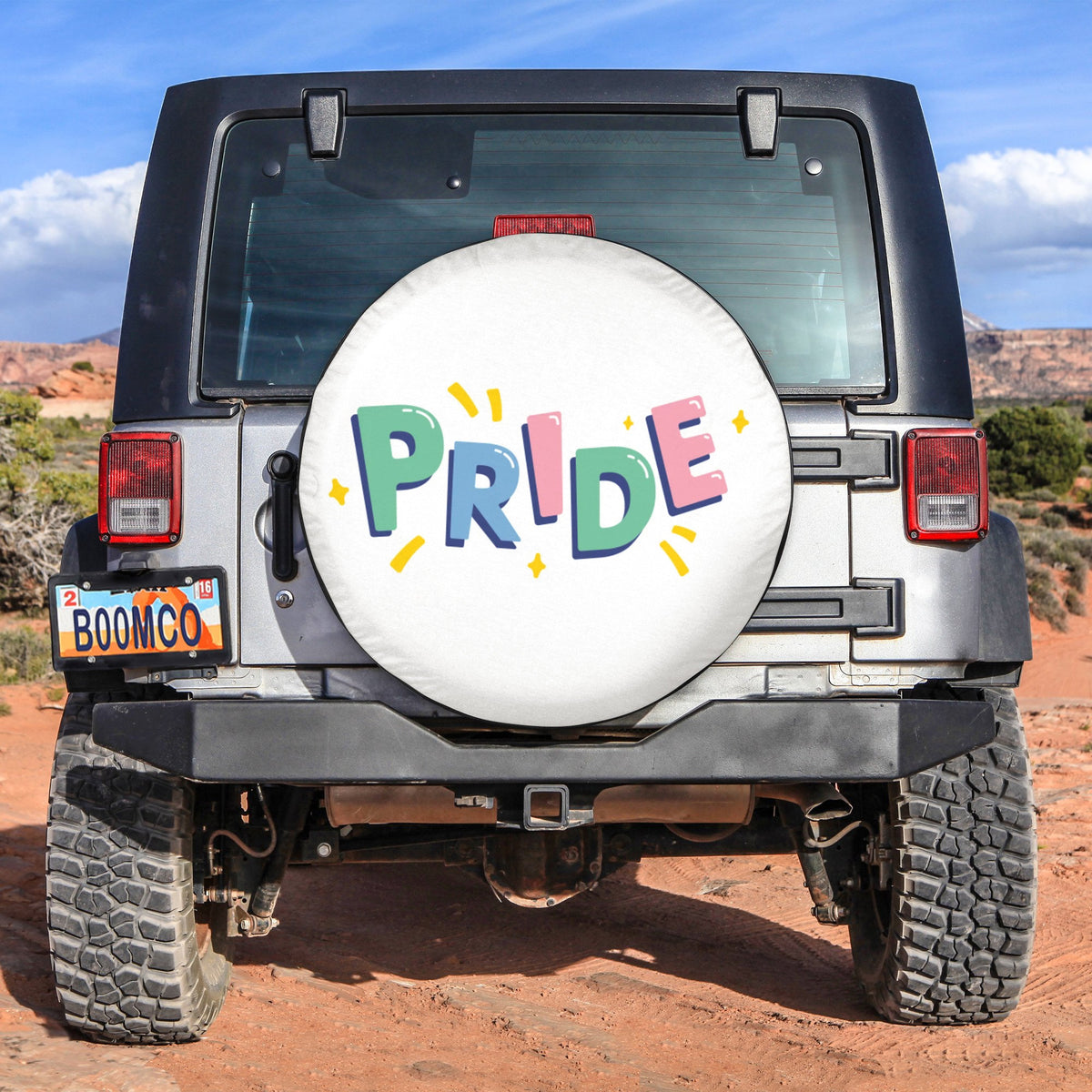 Pride spare tire cover with colorful PRIDE lettering on a white round panel