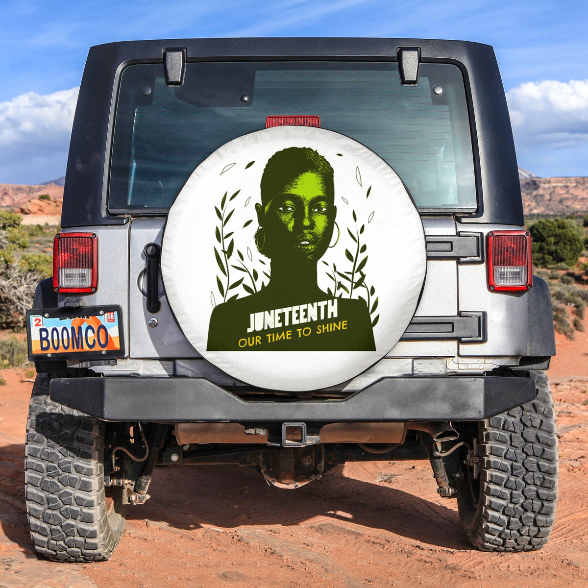 Black spare tire cover with circular white woman design and Juneteenth text