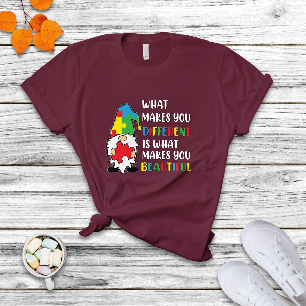 Maroon autism support gnome T-shirt with colorful “What makes you different…beautiful” text