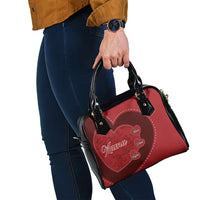 Red heart patch handbag with black top handles and visible strap hardware