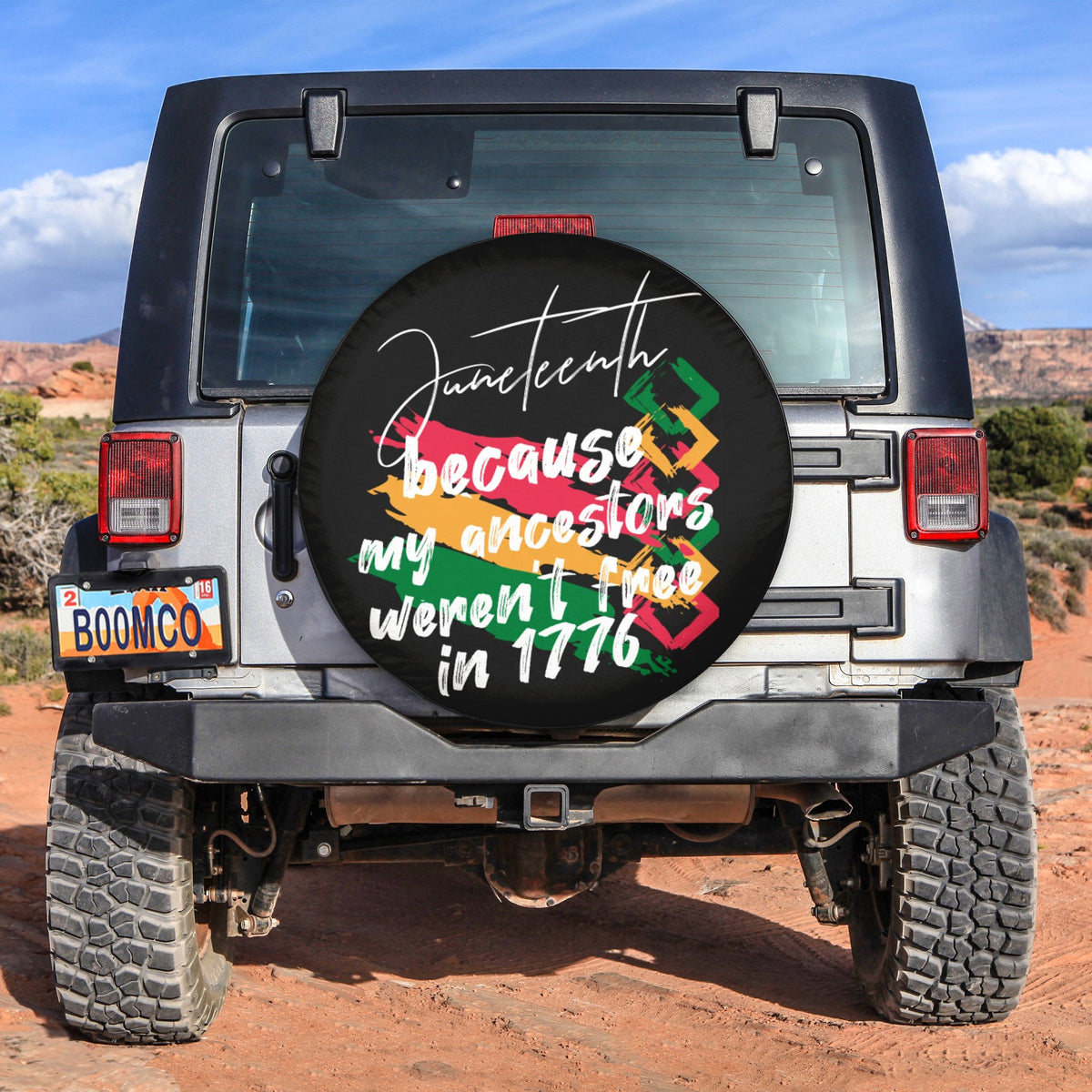 Black round Juneteenth spare tire cover with colorful text graphic on front