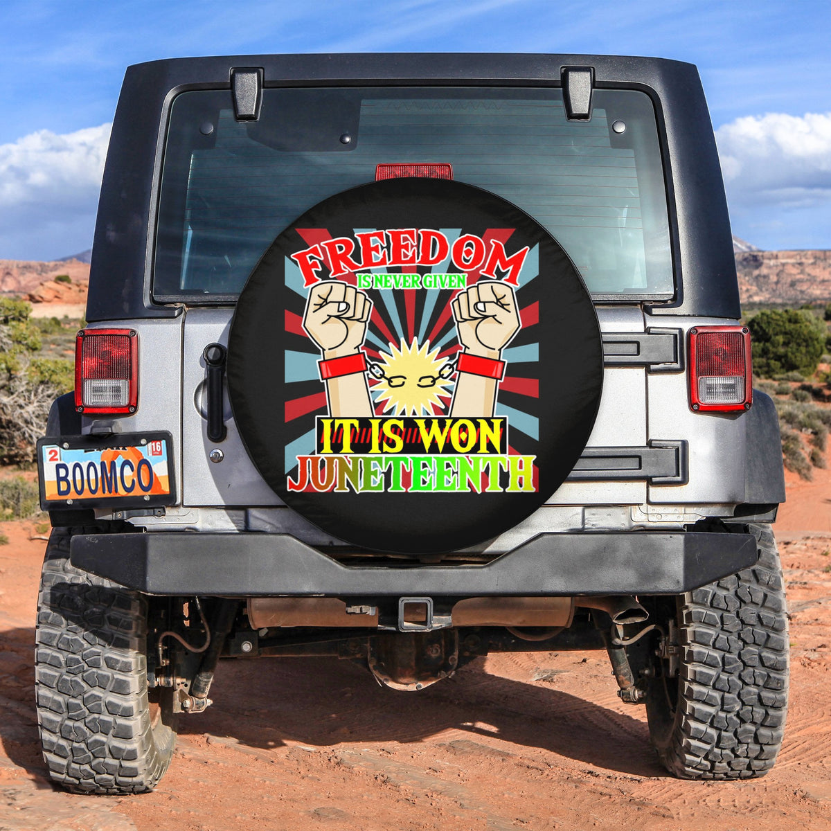 Juneteenth spare tire cover with bold Freedom It Is Won graphic on dark cover