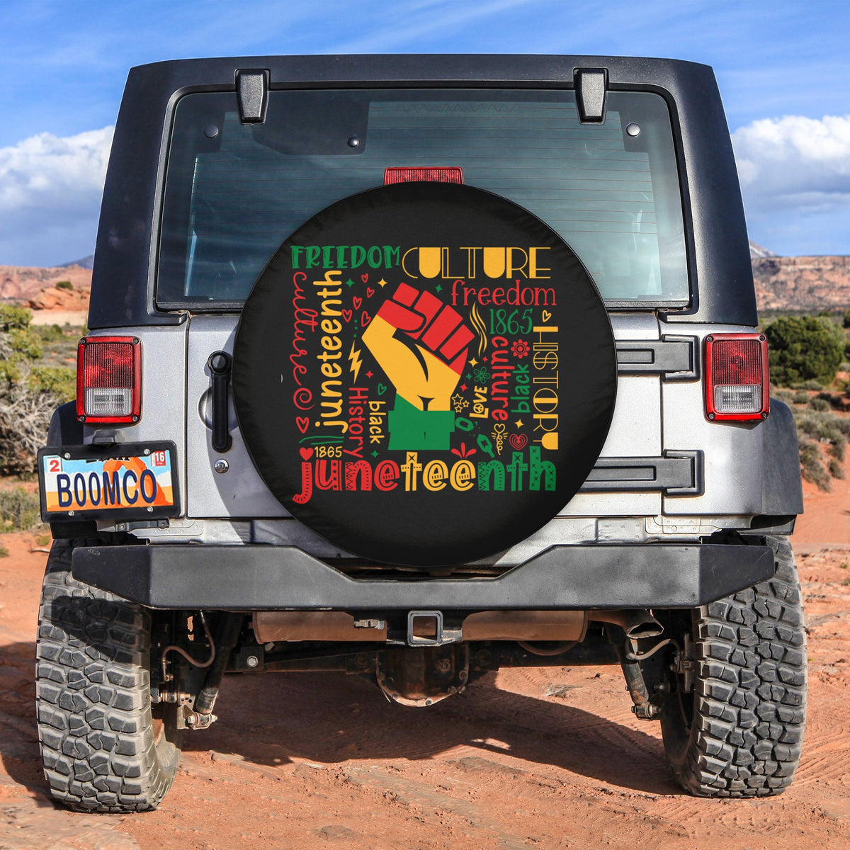 Black circular spare tire cover with colorful Juneteenth lettering and Freedom graphics.