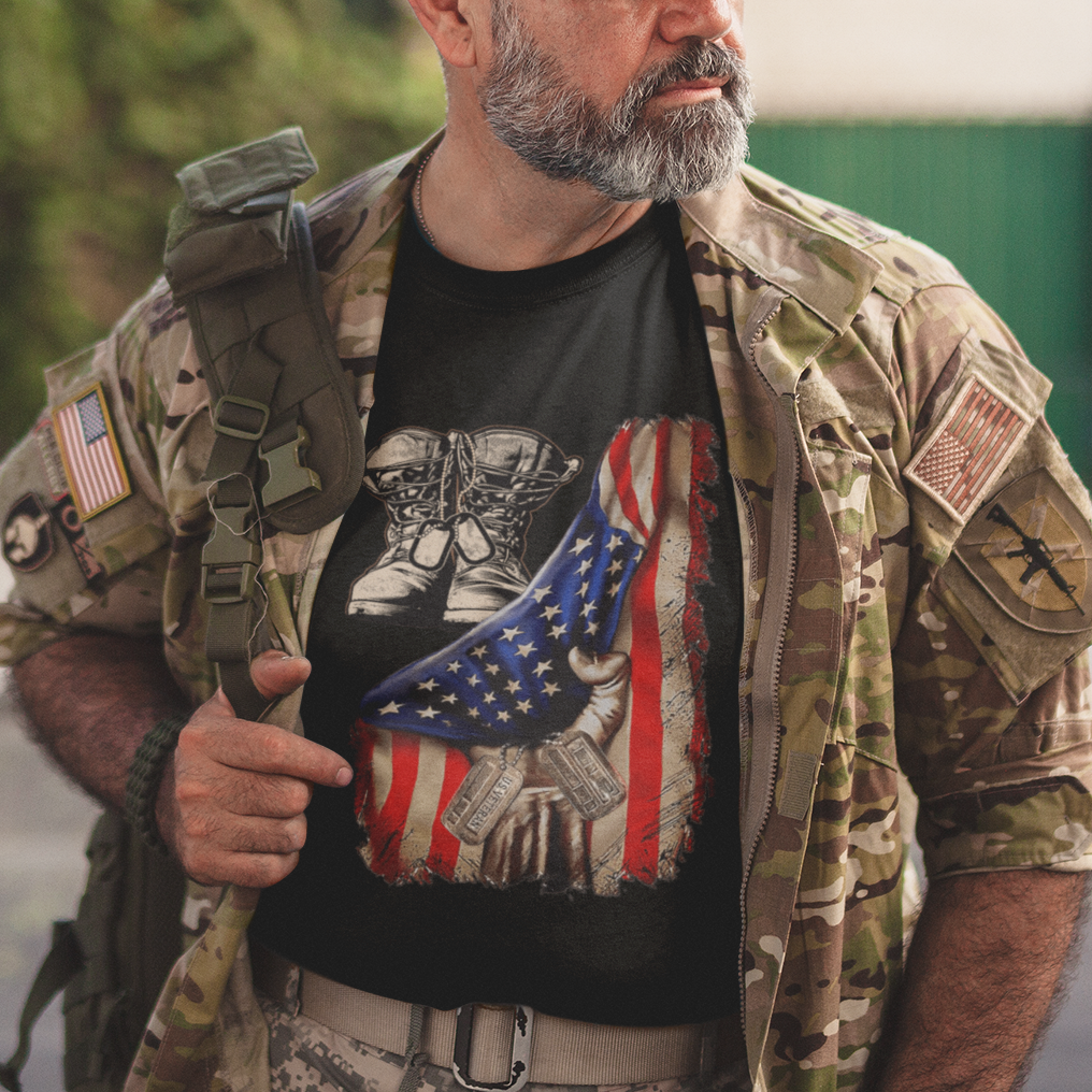 Black T-shirt with distressed American flag graphic, combat boots and dog tags