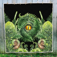 Green dinosaur quilt with fern leaves, seashell accents, and central eye motif
