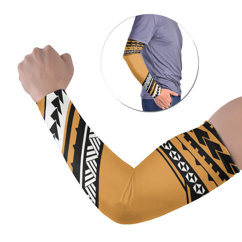 Gold Polynesian arm sleeve with black geometric pattern and cuff trim