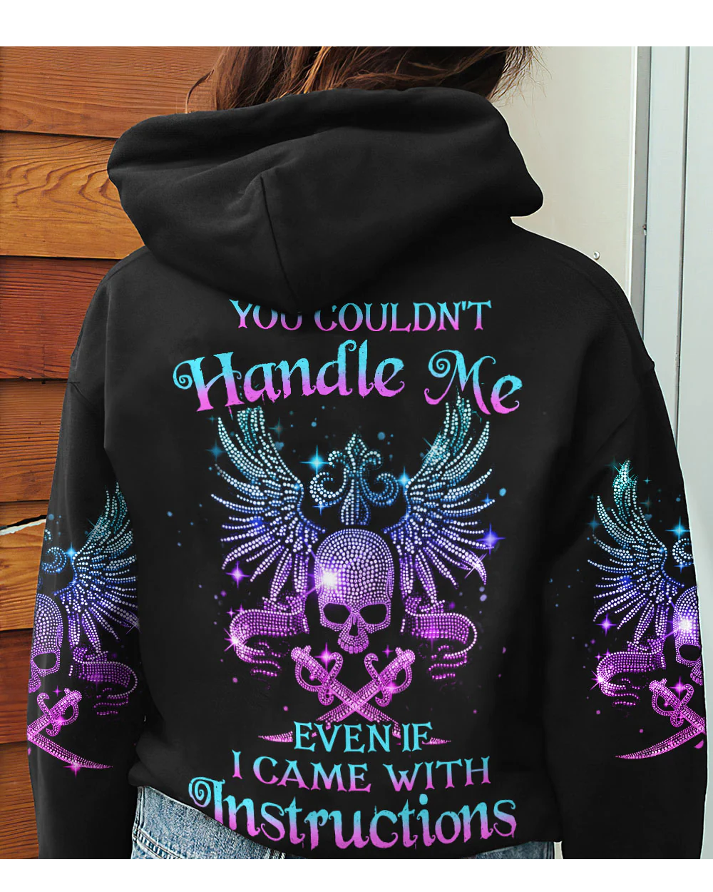 Black hoodie with winged skull graphic and rainbow text on back, hood and sleeves