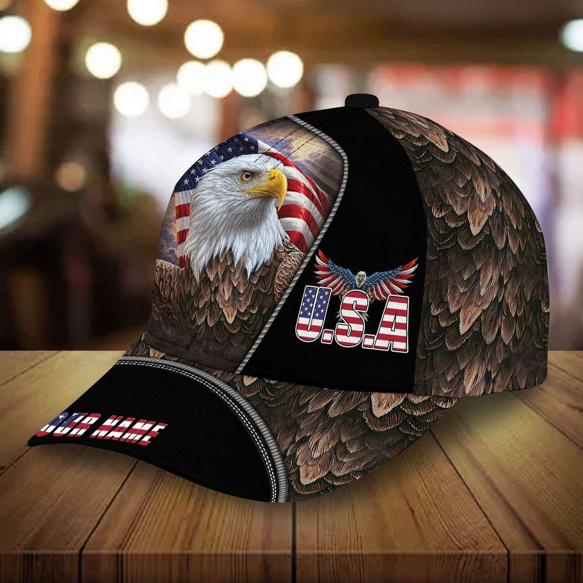 Black-and-brown baseball cap with eagle artwork, U.S.A. badge, and patriotic flag panel
