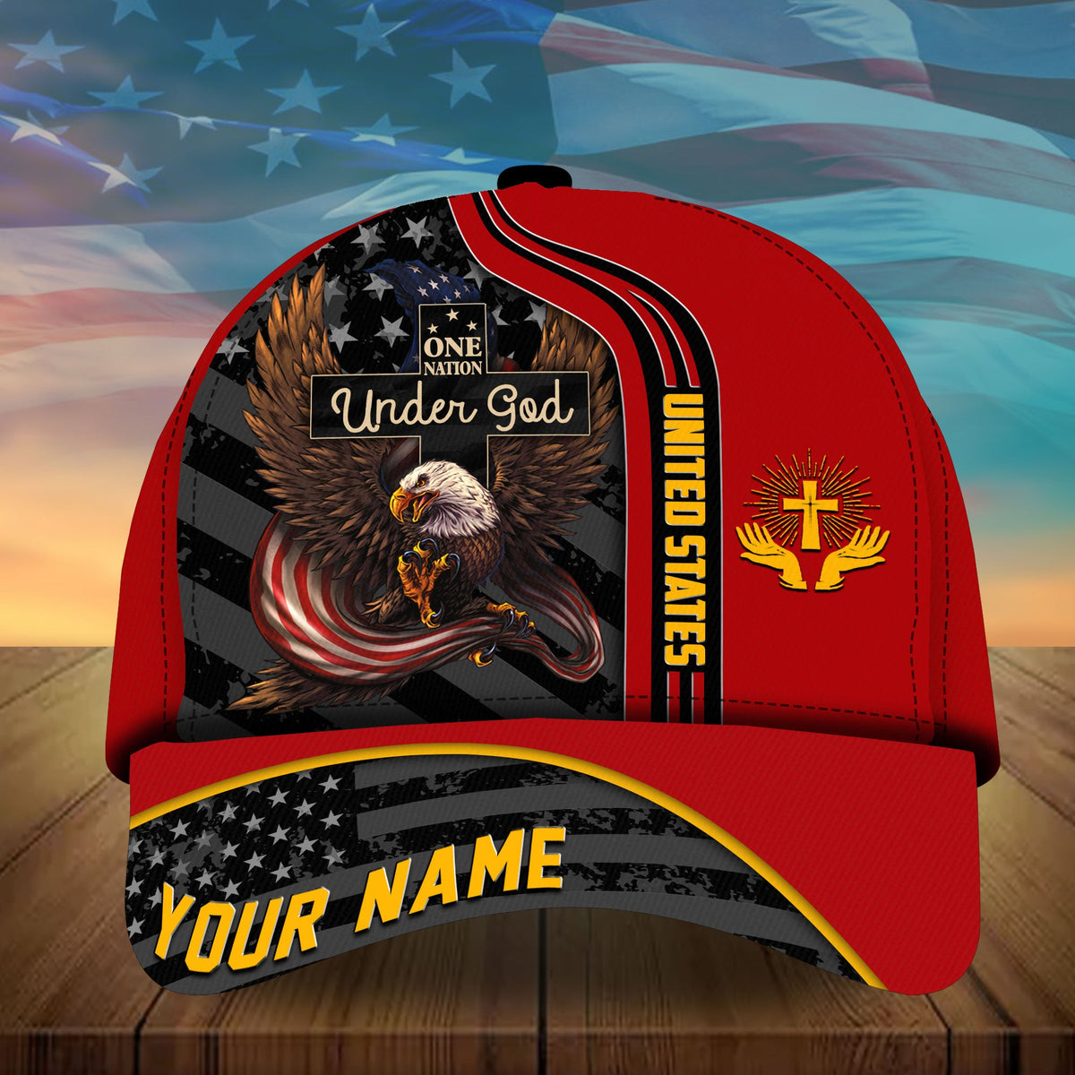 Red baseball cap with eagle graphic, “Under God” panel, and “YOUR NAME” brim text