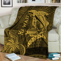 Hawaii shark and turtle blanket in olive with gold kakau pattern, draped on sofa