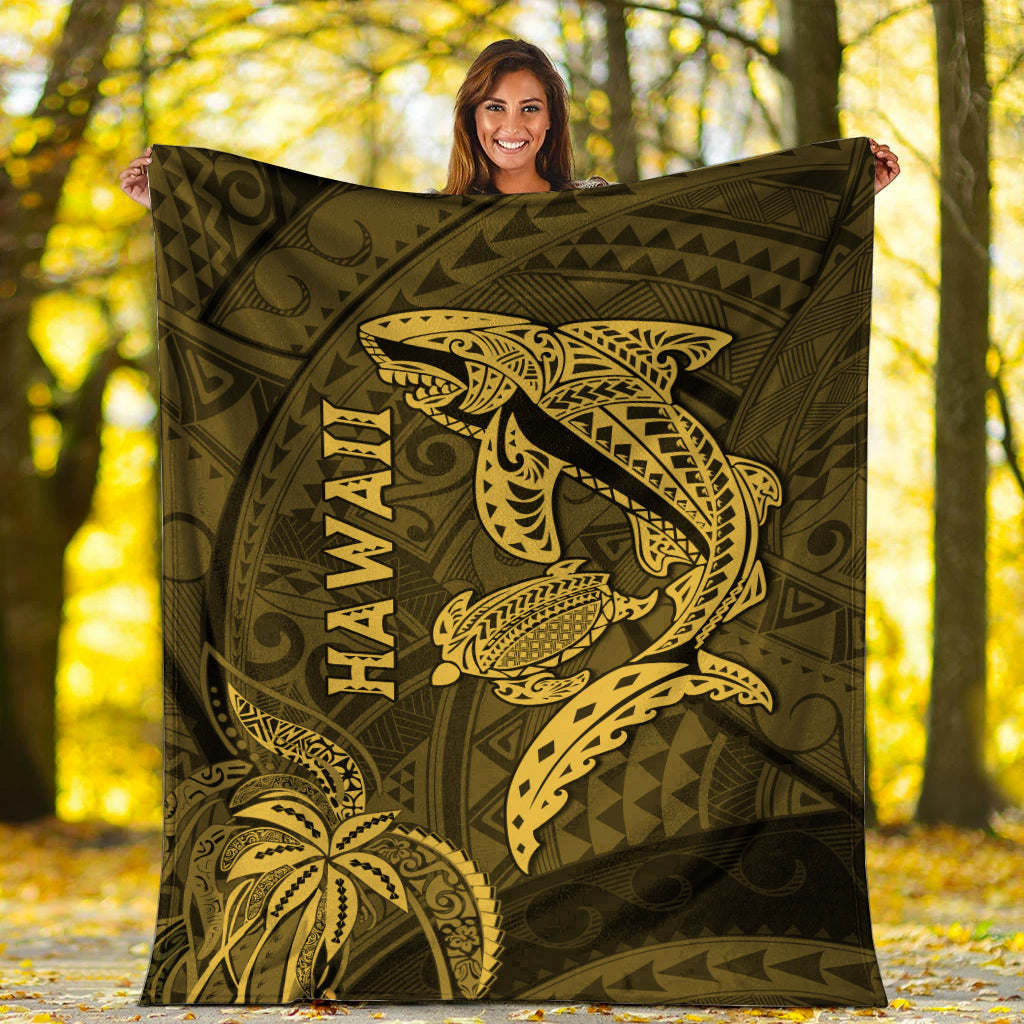 Hawaii shark and turtle blanket in olive with gold kakau pattern, held up outdoors