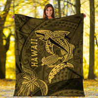 Hawaii shark and turtle blanket in olive with gold kakau pattern, held up outdoors