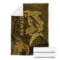 Hawaii shark and turtle blanket in olive with gold kakau pattern, shown flat with towels