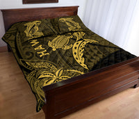 Olive quilt on bed with gold shark and turtle print and HAWAII lettering