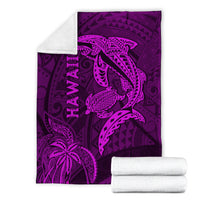 Purple Hawaii shark and turtle blanket, folded with stacked white towels