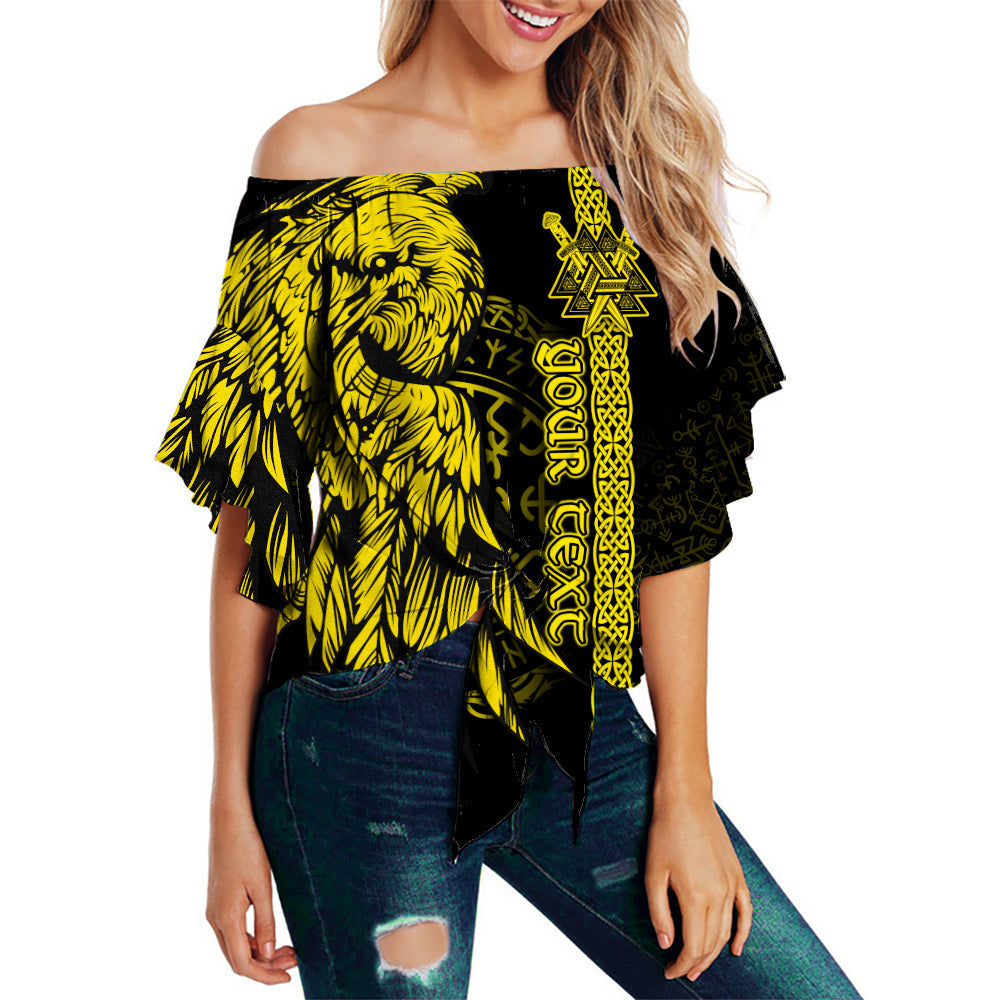 Off-shoulder yellow-and-black top with raven and rune-style vertical print