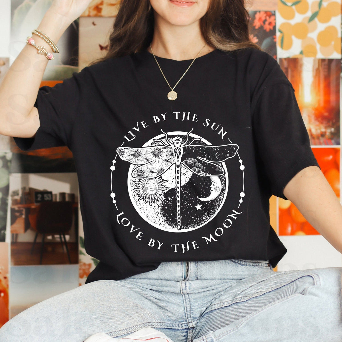 Black dragonfly graphic T-shirt with sun and moon text