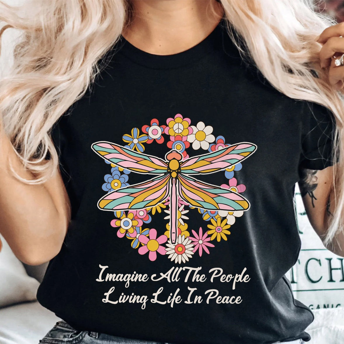 Black peace T-shirt with colorful dragonfly floral graphic and “Imagine...peace” text