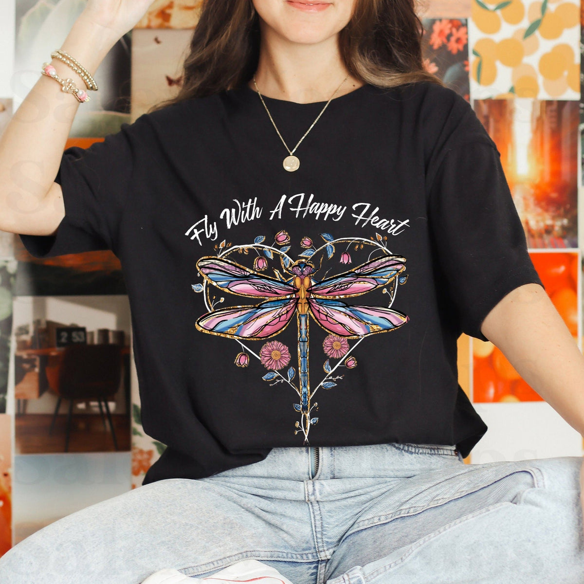 Black graphic T-shirt with “Fly With A Happy Heart” dragonfly and floral design