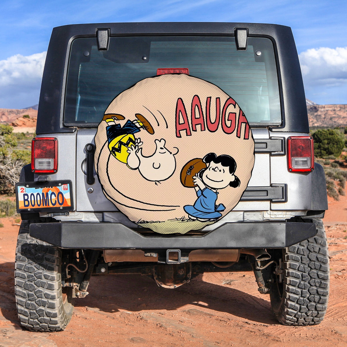 Custom spare tire cover with cartoon character graphic on a dark backing