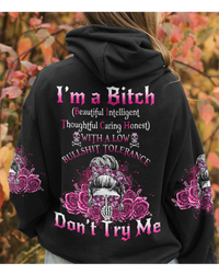 Black pullover hoodie with pink skull graphic, hood, and front pouch pocket