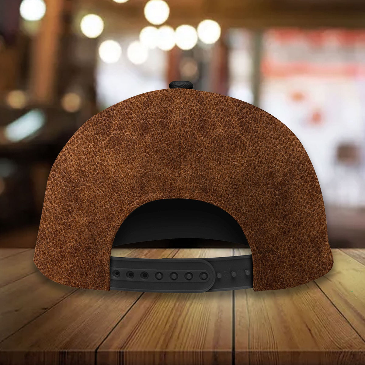 Brown leather baseball cap back view with snapback strap and ventilation eyelets