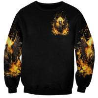 Black crewneck sweatshirt with small angel skull emblem, fiery winged design on chest