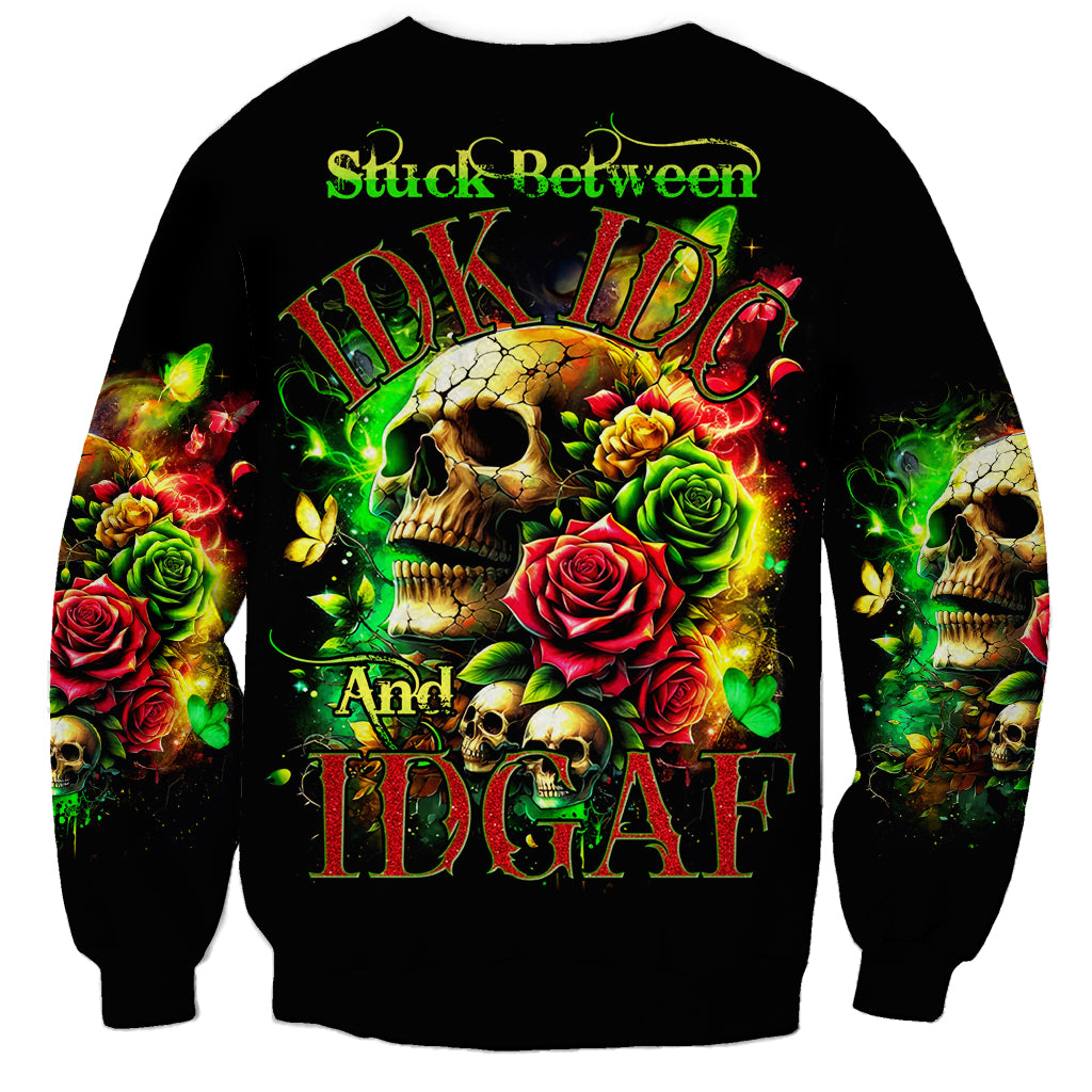 Black sweatshirt with skull and roses front graphic plus 'Stuck Between' text