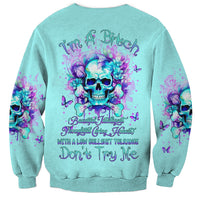 Unisex teal sweatshirt with purple flower skull back graphic and long sleeves