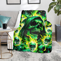 Green flame skull throw blanket with glowing skulls and flames on a living room chair